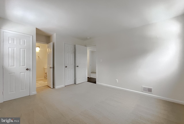 unfurnished bedroom with light colored carpet