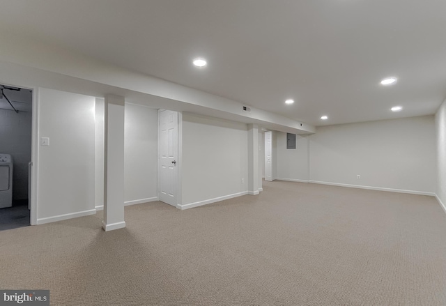 basement with washer / clothes dryer and carpet