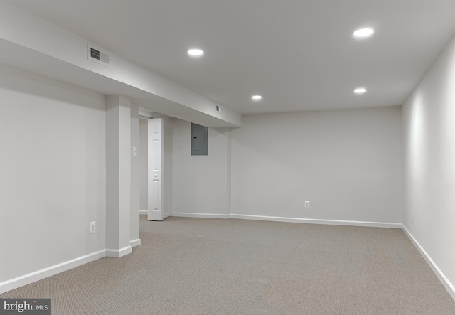 basement with electric panel and carpet flooring