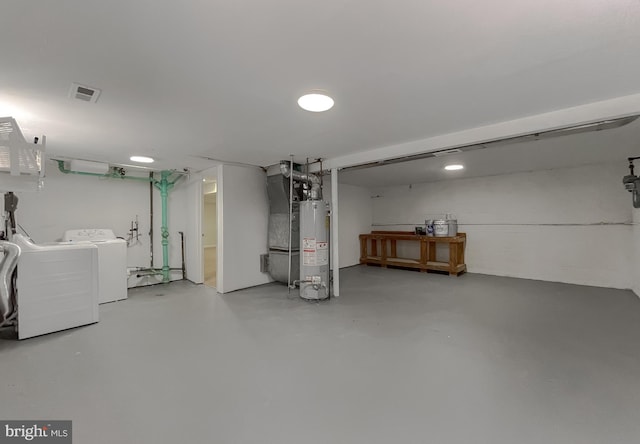 basement featuring independent washer and dryer and water heater