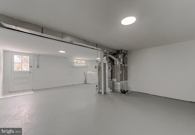 basement with independent washer and dryer, water heater, and heating unit