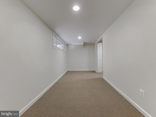 basement featuring light carpet