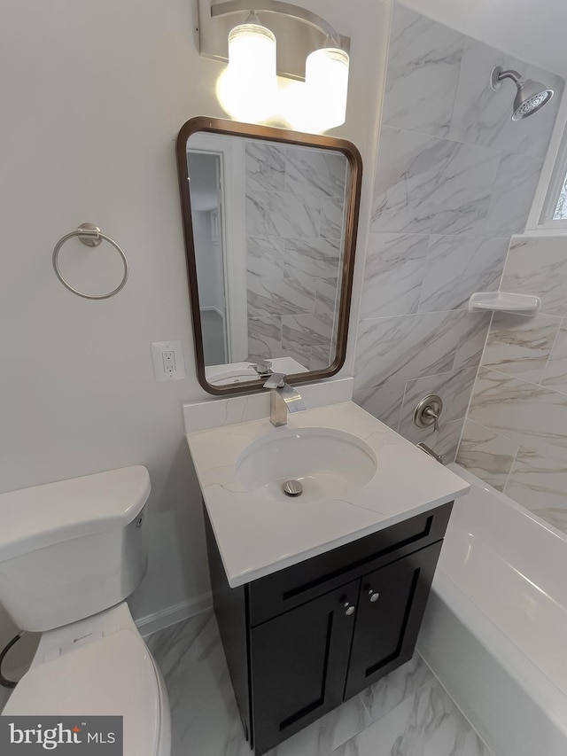 full bathroom with vanity, toilet, and tiled shower / bath