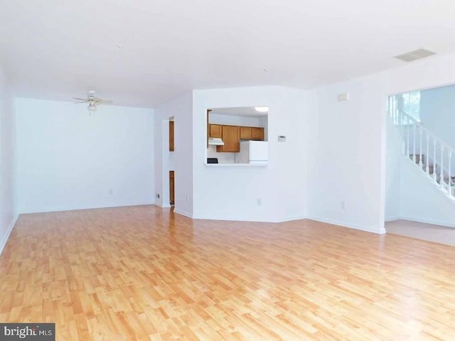 unfurnished living room with ceiling fan and light wood-type flooring