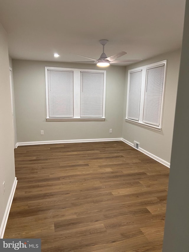 unfurnished room featuring ceiling fan and dark hardwood / wood-style floors