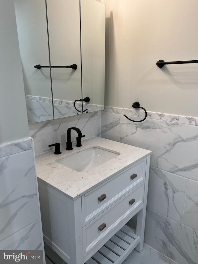 bathroom with tile walls and vanity