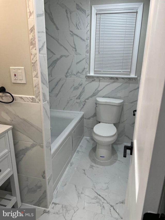 full bathroom featuring bathing tub / shower combination, toilet, tile walls, and vanity