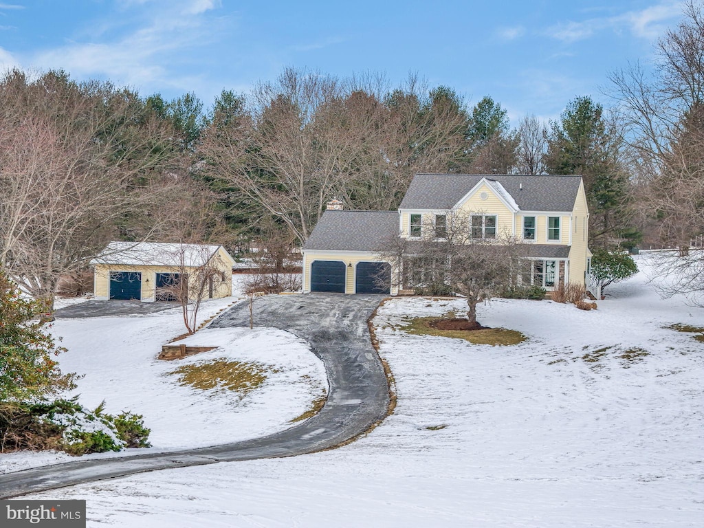 view of front of house with a garage and an outdoor structure