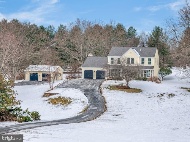 view of front of house with a garage and an outdoor structure