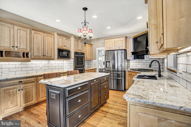 kitchen featuring light stone counters, light hardwood / wood-style floors, black appliances, custom range hood, and a kitchen island