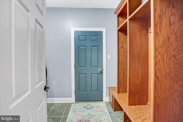 mudroom featuring dark tile patterned flooring