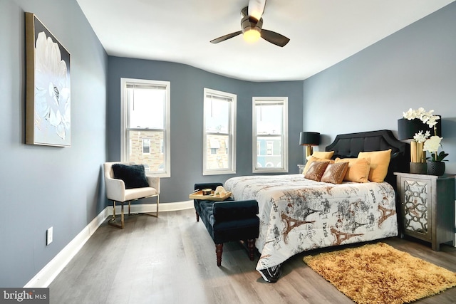 bedroom with ceiling fan and wood-type flooring