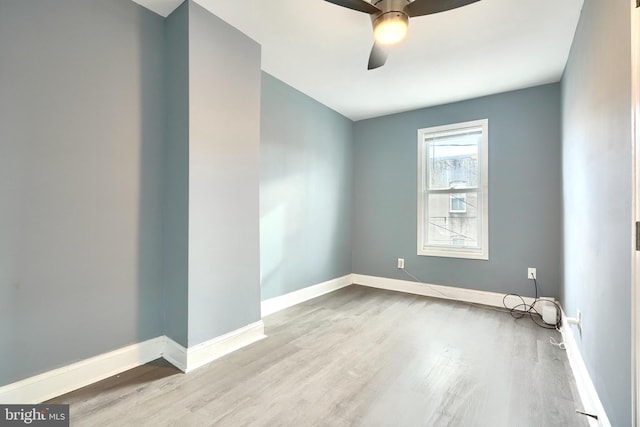 empty room with ceiling fan and light hardwood / wood-style floors