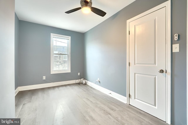 empty room featuring ceiling fan and light hardwood / wood-style flooring