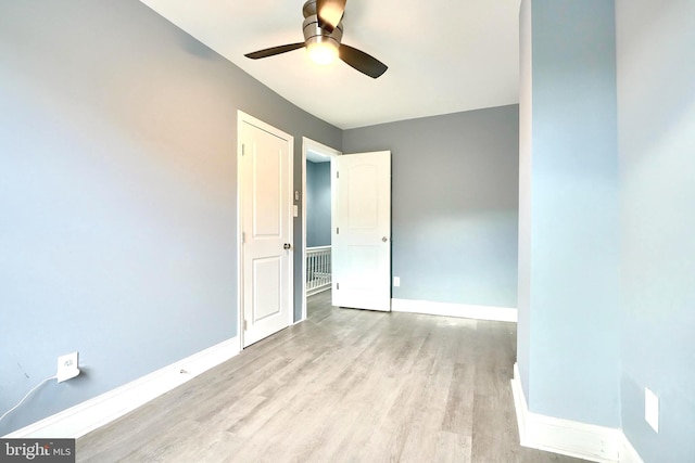 empty room featuring ceiling fan and light hardwood / wood-style floors