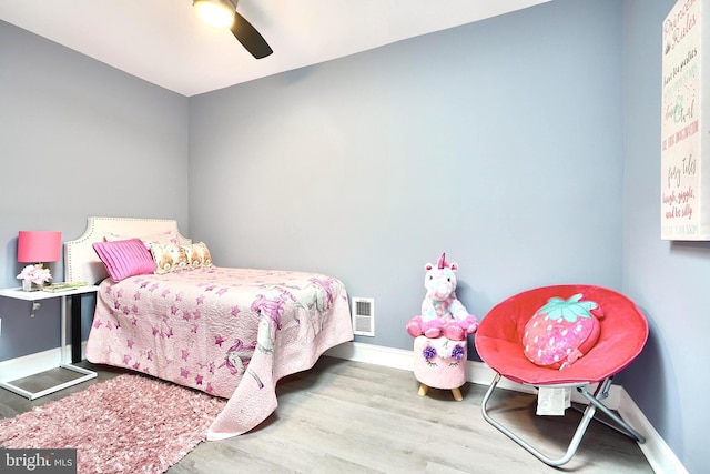 bedroom with ceiling fan and light hardwood / wood-style floors