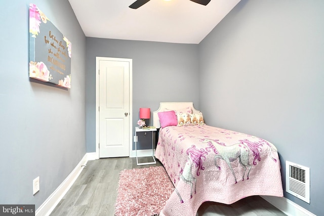 bedroom with ceiling fan and light hardwood / wood-style floors