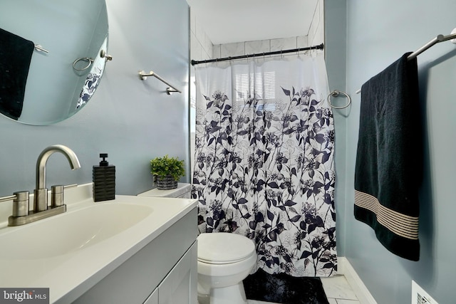 bathroom with vanity, toilet, and curtained shower