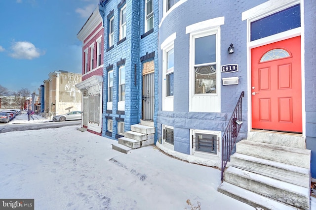 view of snow covered property entrance