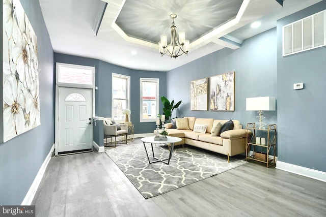 living room featuring wood-type flooring and a notable chandelier