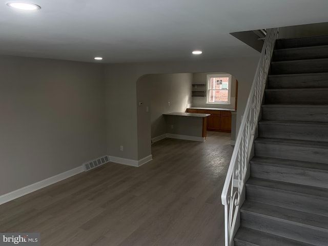 stairs featuring hardwood / wood-style flooring