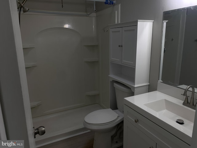 bathroom with vanity, toilet, and walk in shower