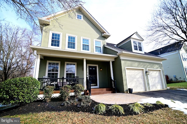 view of front facade with a garage and covered porch