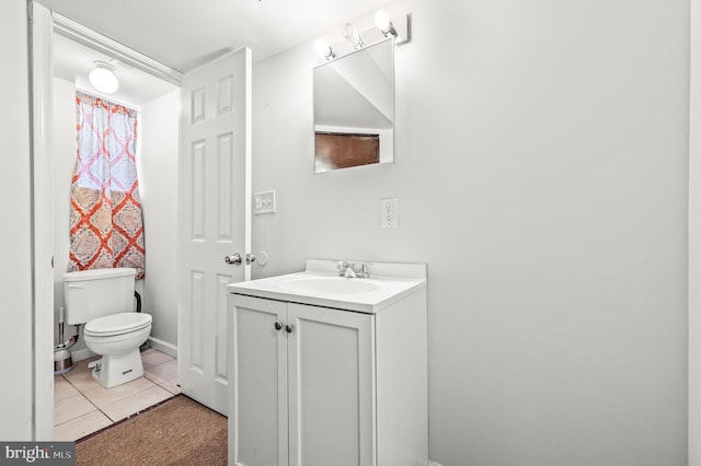 bathroom with toilet, tile patterned floors, and vanity