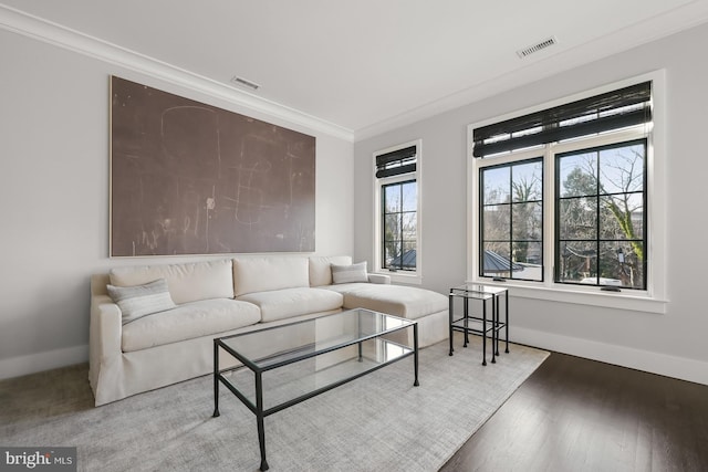 living room featuring ornamental molding and wood-type flooring