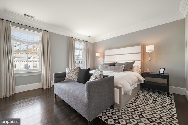 bedroom featuring crown molding and dark hardwood / wood-style floors