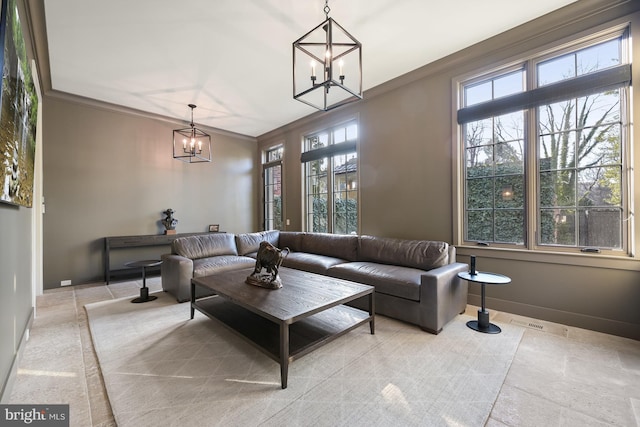 living room featuring crown molding and an inviting chandelier