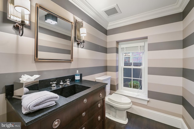 bathroom featuring crown molding, wood-type flooring, toilet, and vanity