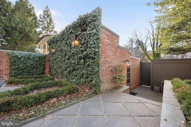 view of side of home with a patio area