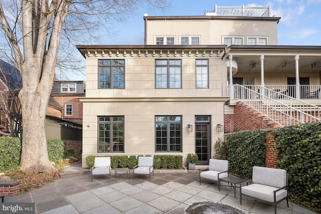 rear view of house featuring a patio and ceiling fan