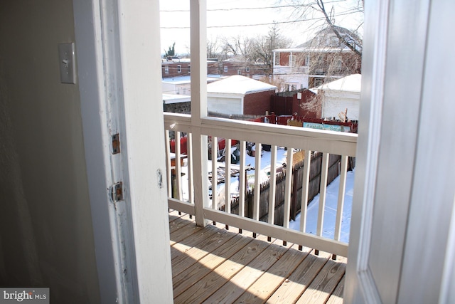 view of snow covered back of property