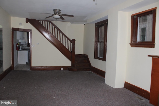 stairs with carpet and ceiling fan