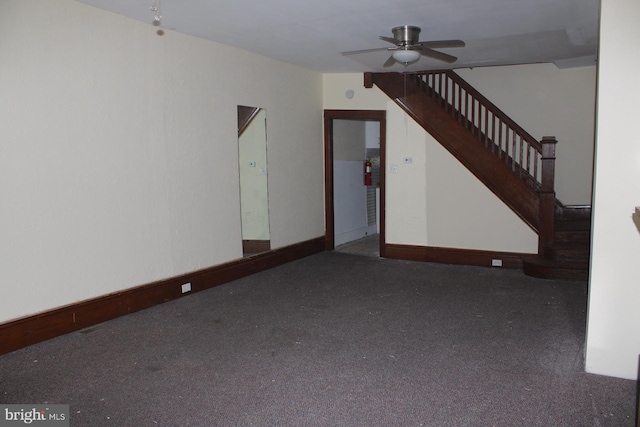 unfurnished living room with dark carpet and ceiling fan