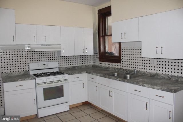 kitchen featuring decorative backsplash, sink, white range with gas stovetop, and white cabinets