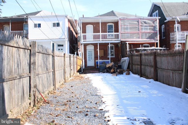 snow covered property featuring a balcony