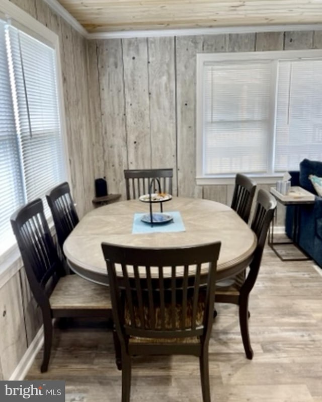 dining space featuring wood ceiling, light hardwood / wood-style floors, and a wealth of natural light