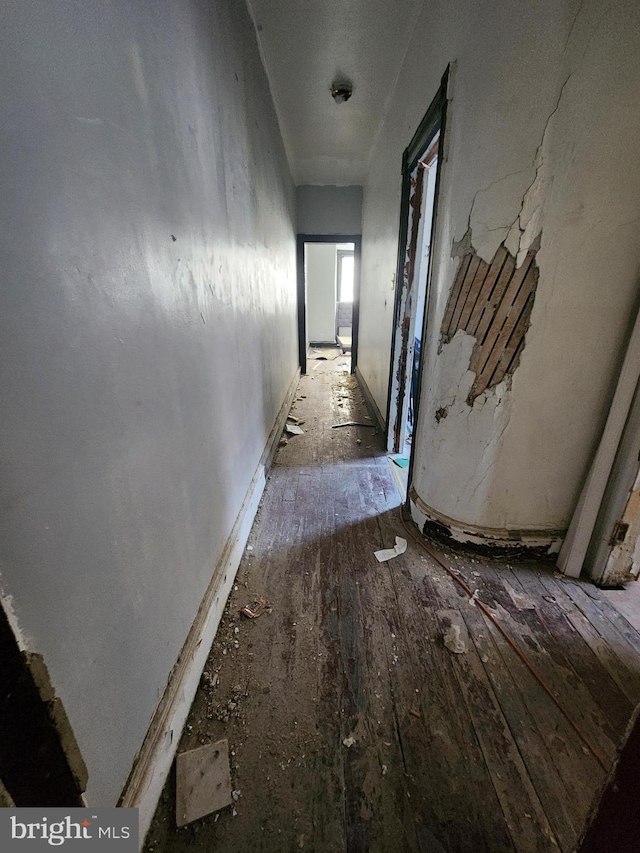 corridor with hardwood / wood-style floors