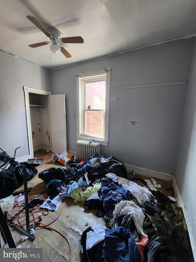 bedroom with radiator and ceiling fan