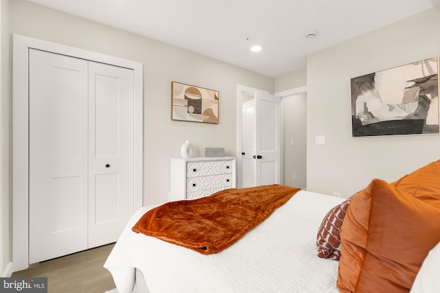 bedroom featuring light wood-type flooring and a closet