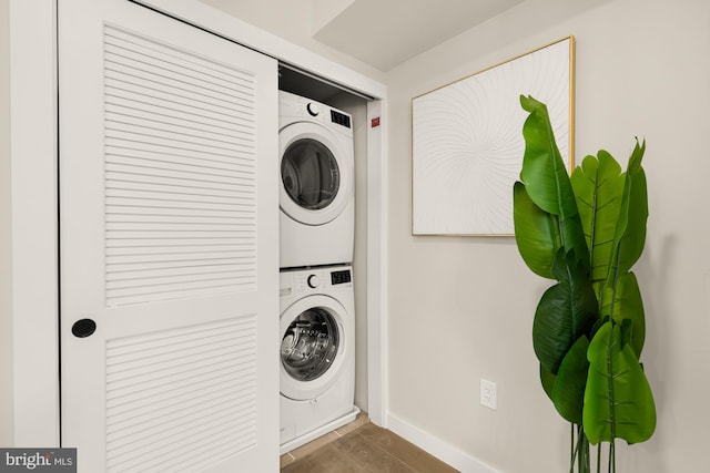 laundry room with stacked washing maching and dryer