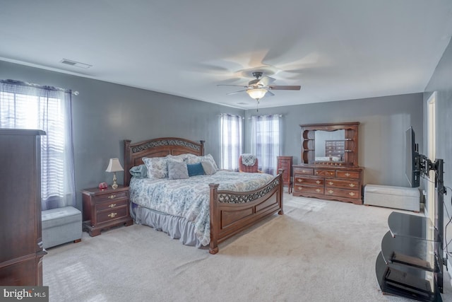 bedroom with carpet, multiple windows, visible vents, and a ceiling fan