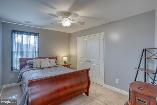 bedroom with light carpet, ceiling fan, and baseboards