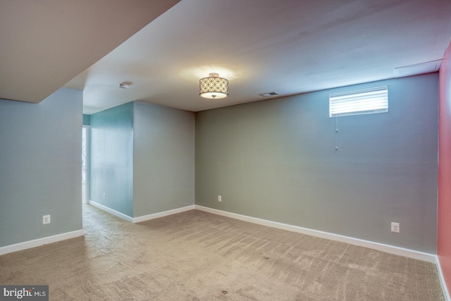 basement featuring carpet flooring, visible vents, and baseboards