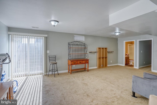 living area with carpet floors, visible vents, and baseboards