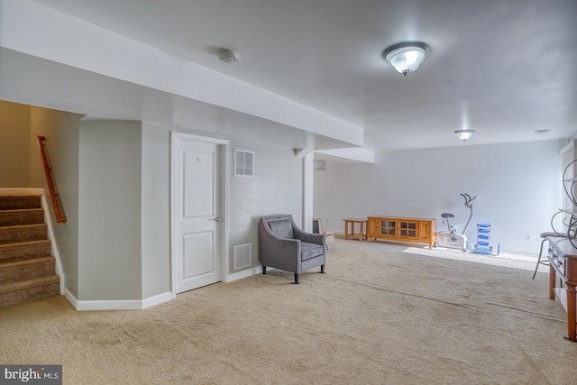 unfurnished room with carpet floors, visible vents, baseboards, and stairs