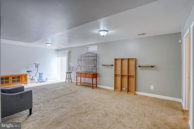 living area featuring carpet floors, visible vents, and baseboards